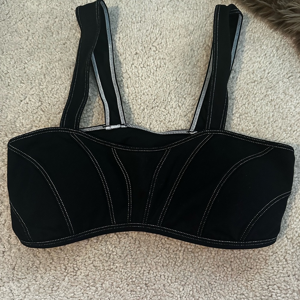 Alo black with white strips sports bra as seen on Kylie Jenner